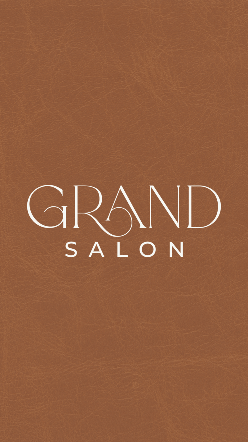 Text GRAND SALON in elegant white font on a textured brown background that resembles leather, perfect for an upscale hair salon website design.