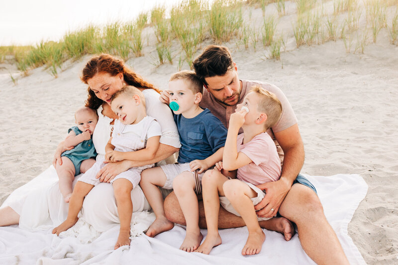 Family of five with three boys under five walking on the beach in Ocean City, New Jersey