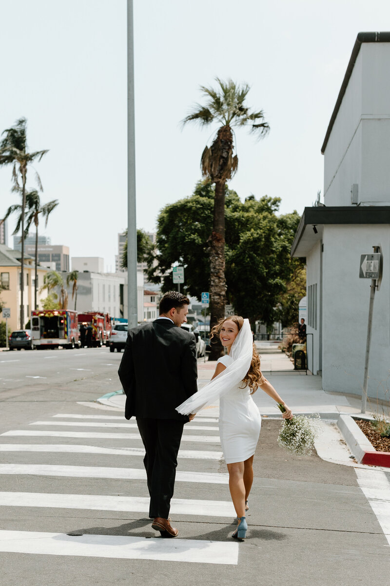 bride and groom walking on road