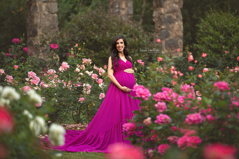 Pregnant woman at Raleigh Rose Garden enjoying her maternity photos