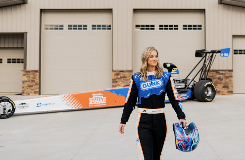 megan meyer standing next to race car