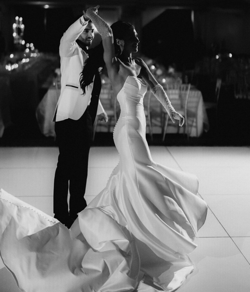 Couple Smiling and Embracing as wind blows veil