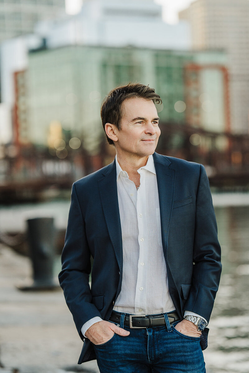 man in blazer gets headshot taken in boston seaport