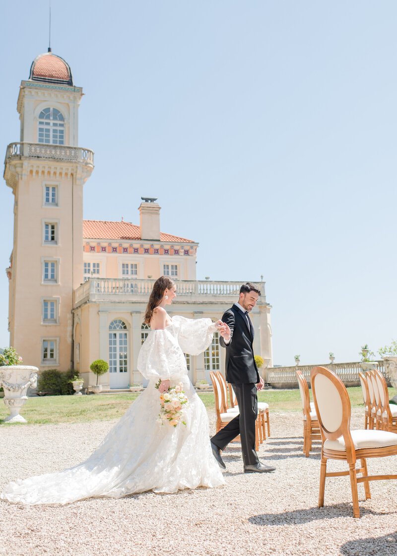 Wedding Photographer, Groom leans into bride sweetly, she smiles in her wedding dress and with bouquet