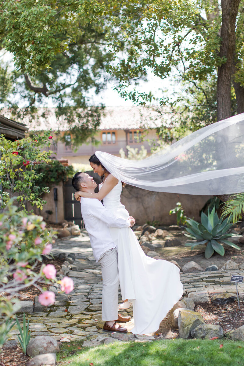 groom lifting bride at rancho buena vista wedding