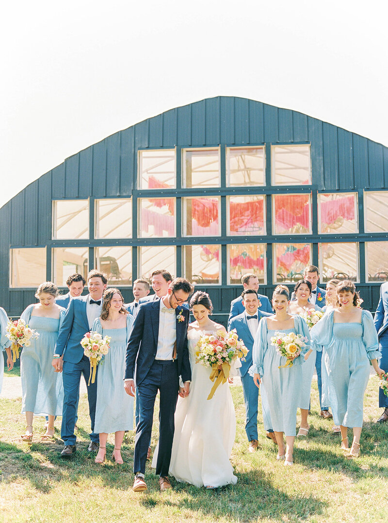 bride-groom-and-wedding-party-in-front-camino-real-ranch