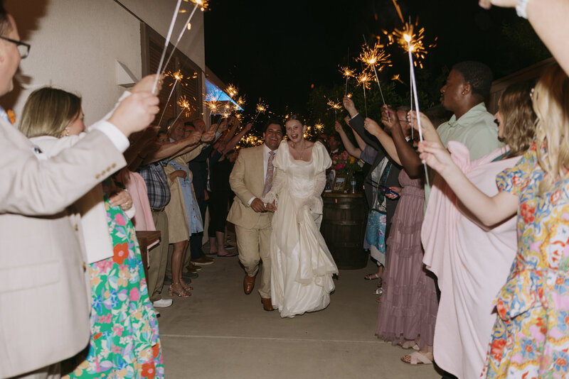 Regan and Yered running through their sparkler exit at their wedding.