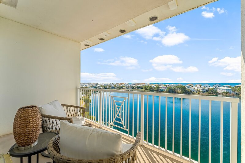 balcony with brown wicker chairs with white cushiosn