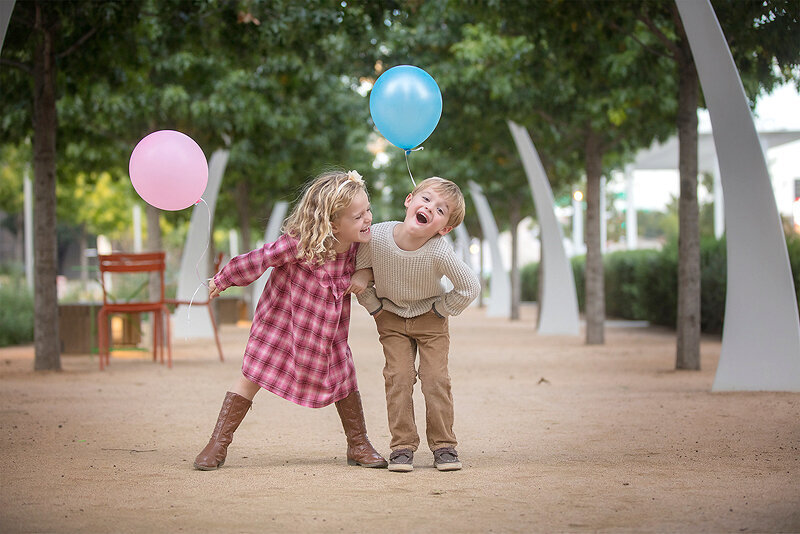 Twins laughing at Klyde Warren Park.