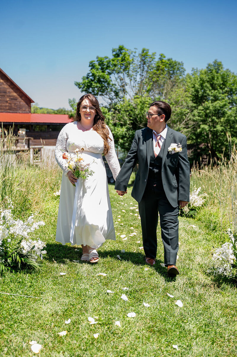 Bride and groom walking holding hands
