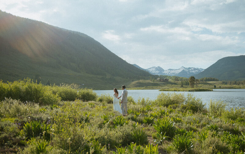 A couple walking by a mountain lake during their Colorado elopement