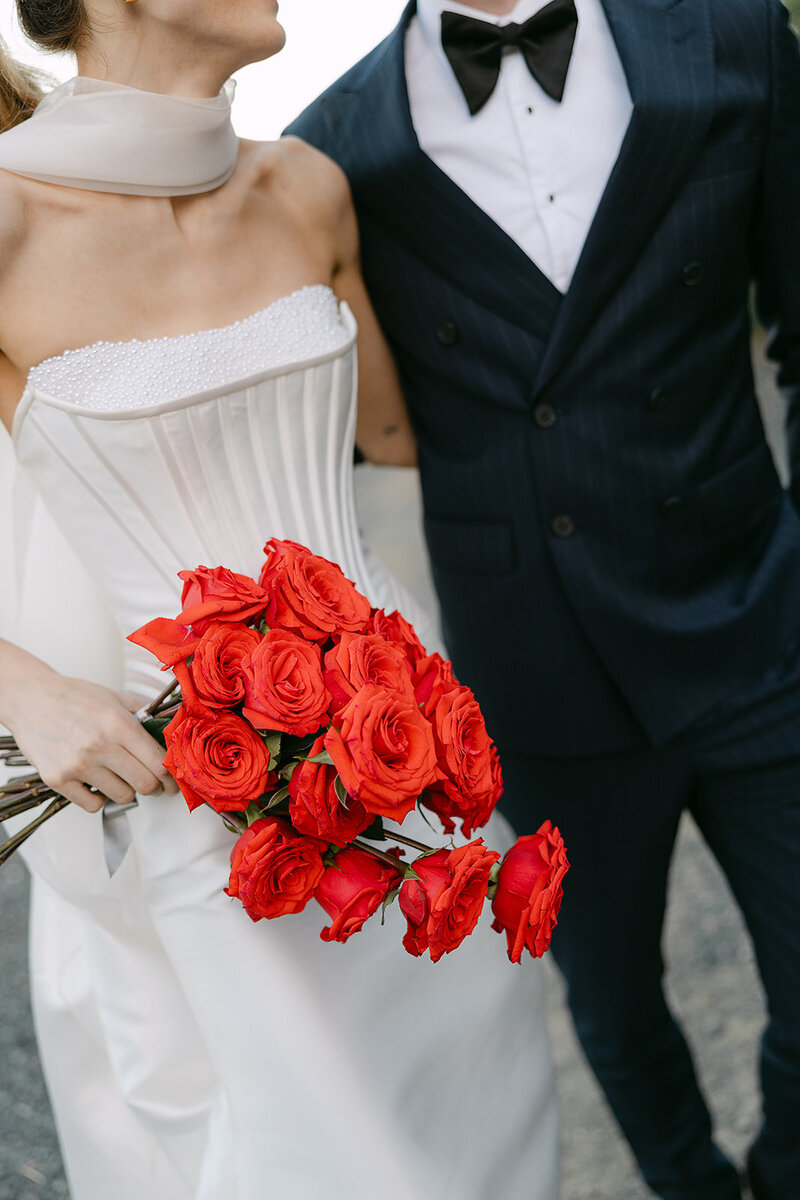 bride with bow on dress walking up stairs with husband