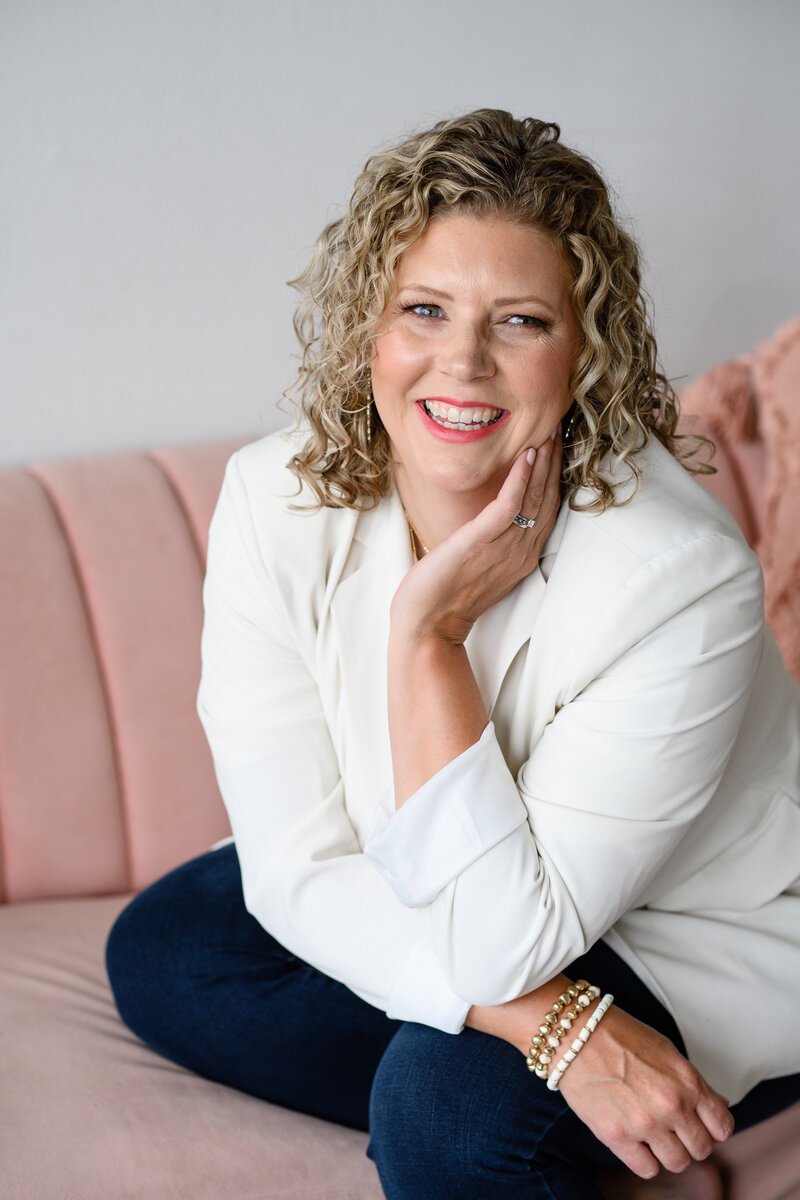 A christian business podcast owner sitting on a couch.