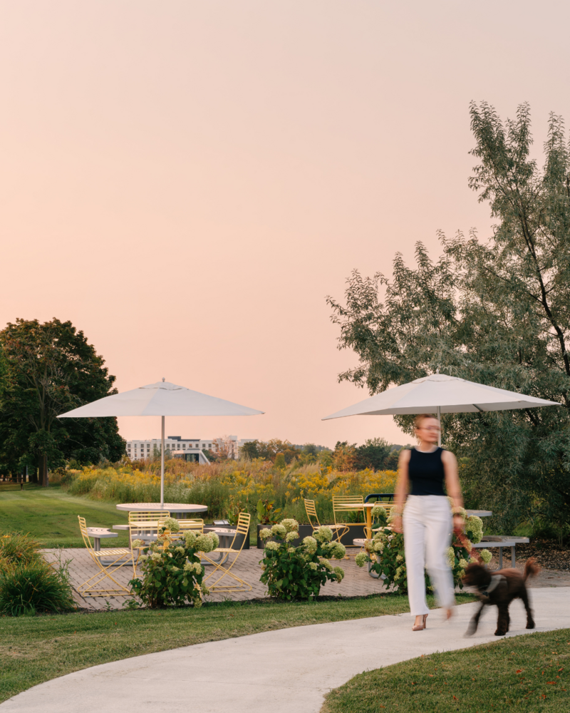 A lush outdoor lounge  featuring a community seating area and  footpath