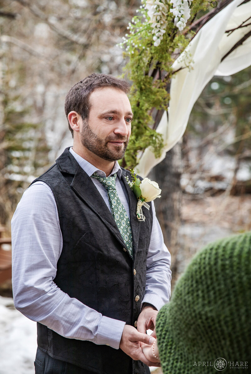 Groom During Wedding Ceremony at Romantic Riversong Inn Estes Park