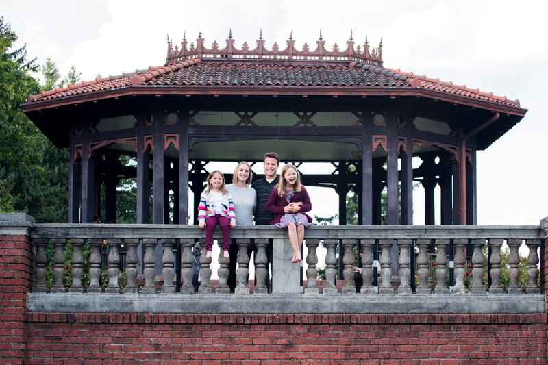 family posing by gazebo