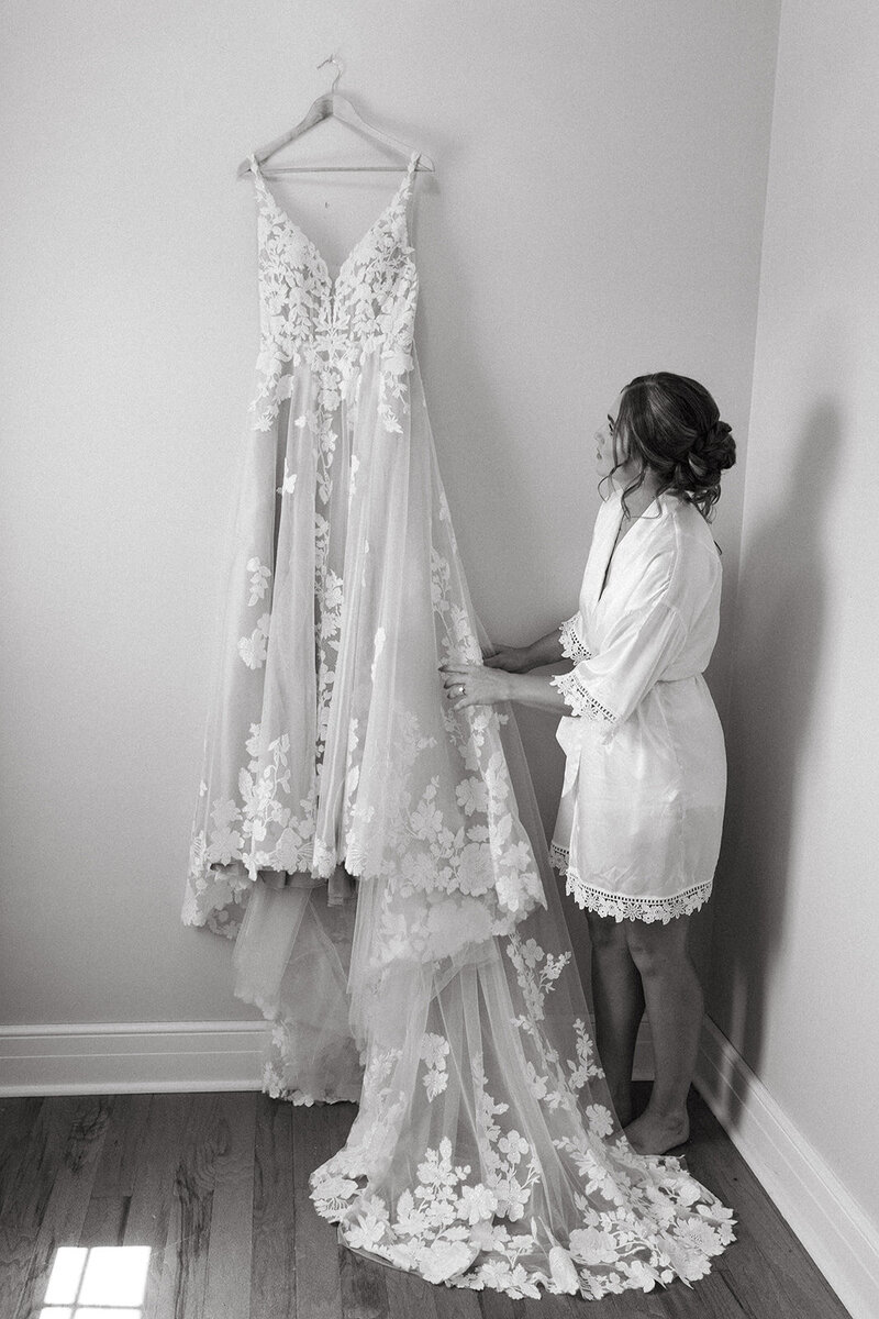 bride admiring dress St. Louis Wedding Photographers