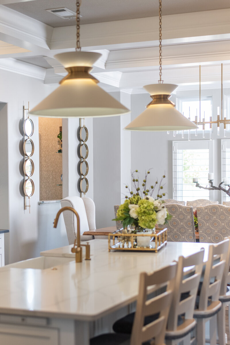 High end pendant lights are showcased over a high end kitchen island