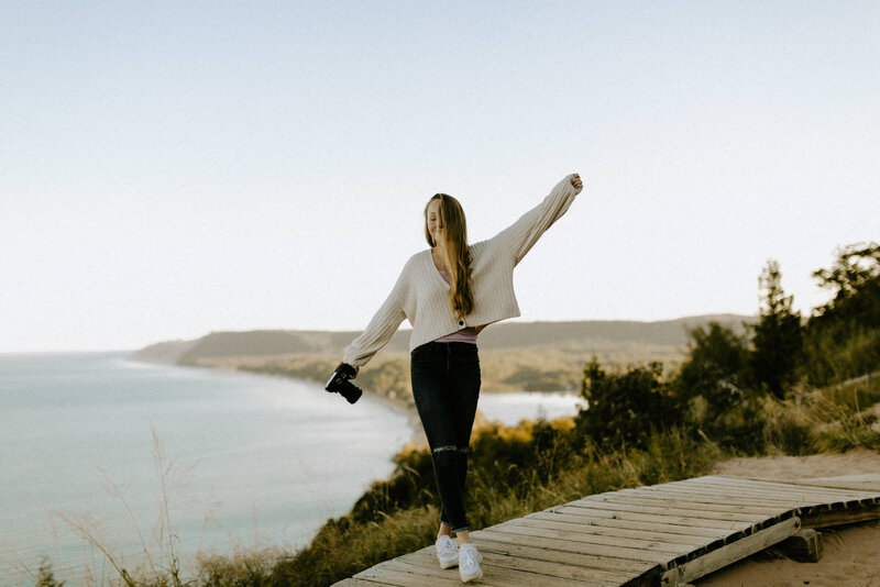 A photographer standing on a bluff overlooking lake Michigan near Traverse City. 