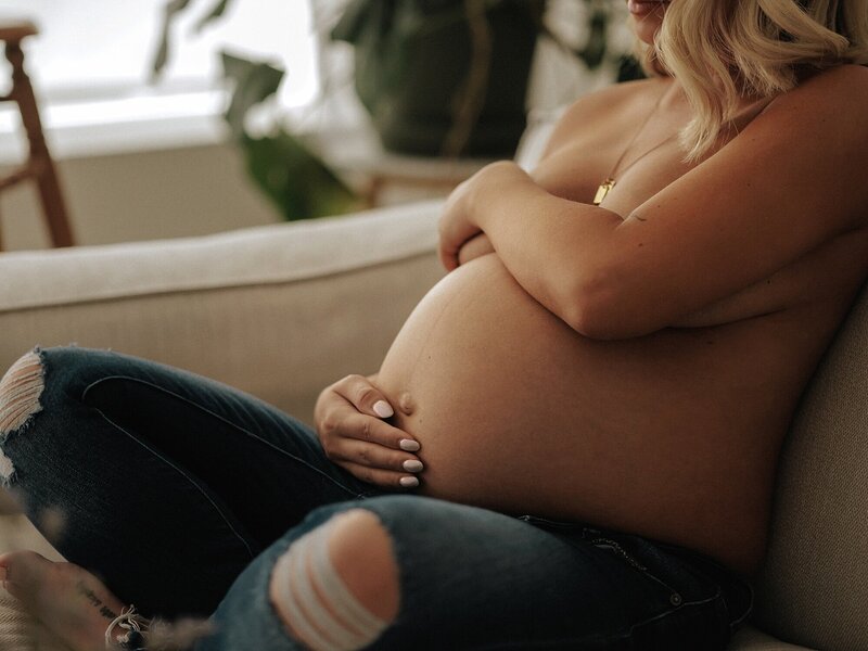 Pregnant mother seated during a lifestyle maternity photography session
