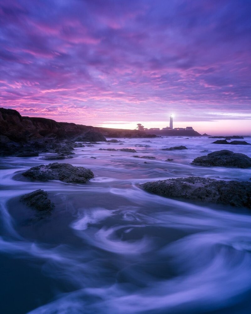 lighthouse beacon and a purple sunset