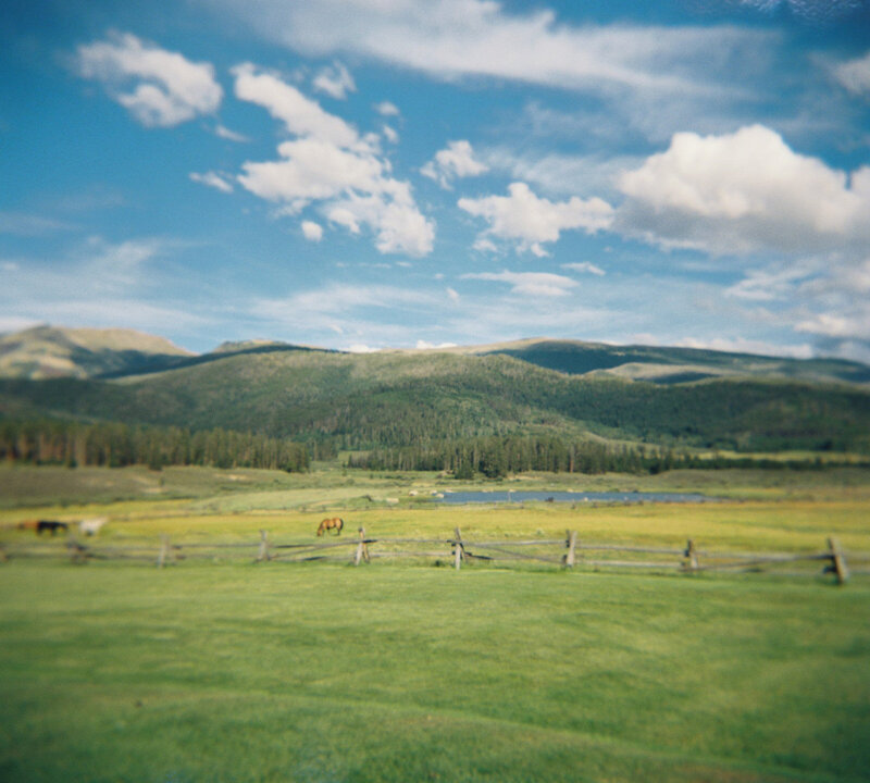 Holga film landscape of Devil’s Thumb Ranch meadow with trees and rustic scenery.