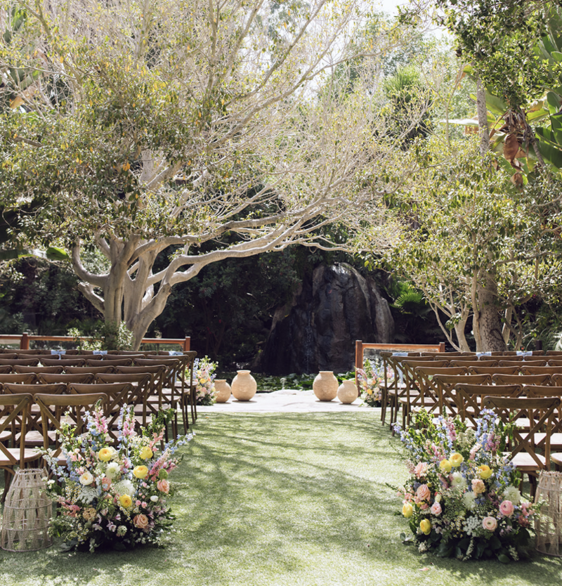outdoor ceremony with colorful floral arrangements