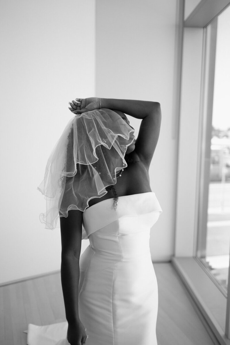 Black and white bridal portrait with layered veil and modern off-shoulder gown – editorial wedding photography by Madison Dodd Photo