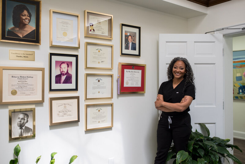 Dr. Dawn Broyles,  Cincinnati Dentist and dental implant specialist, smiles in her Cincinnati office lobby