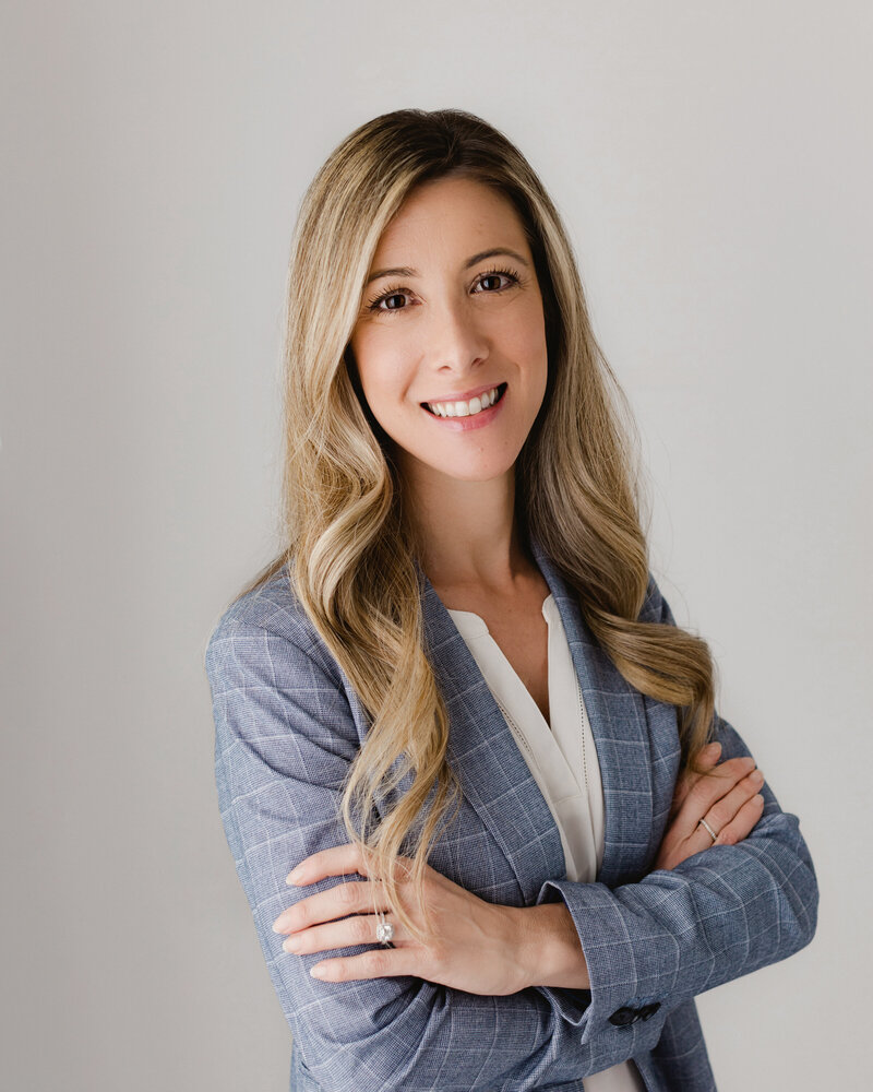 Woman in blue blazer poses for headshot