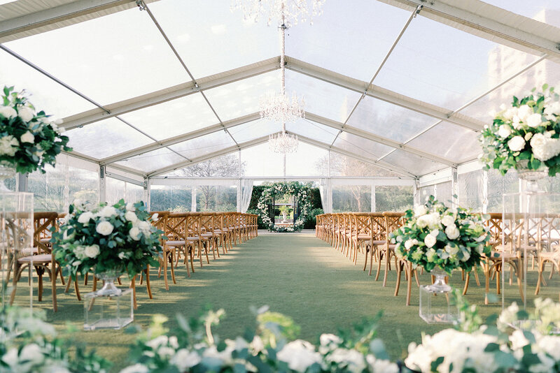 Bride and groom kissing while bridal party cheers around them