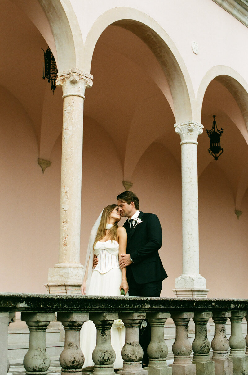bride and groom kissing at ringling museum in sarasota florida