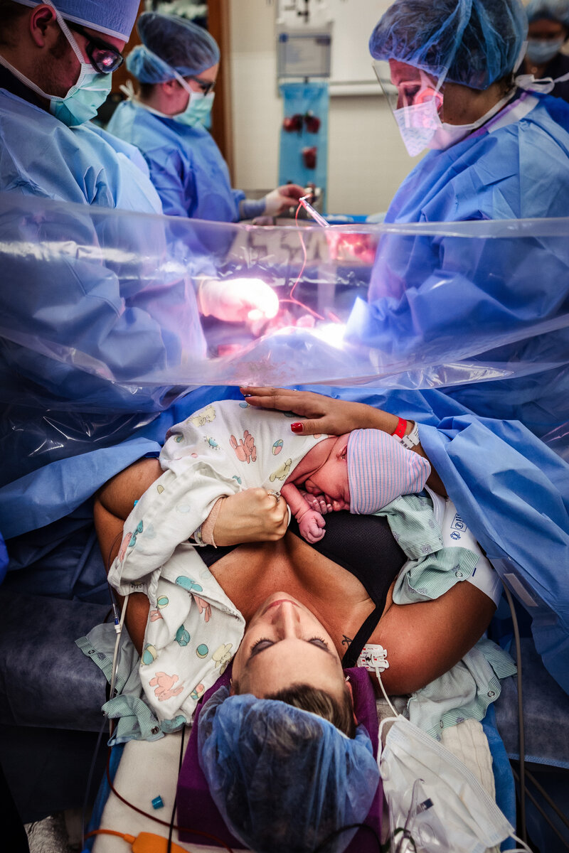 a Montana mother holds her newborn after a cesarean birth in Billings Montana Montana Doula, Birth Photographer & Birth Advocate