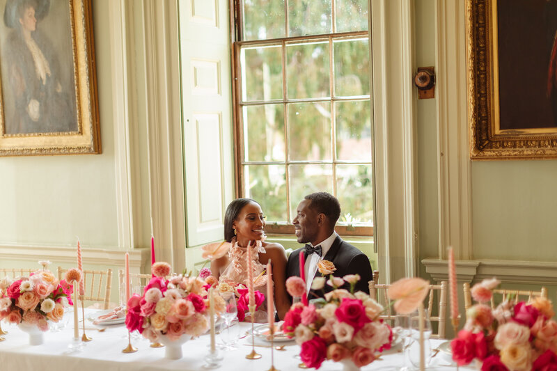 bride and groom at top table with pink flowers