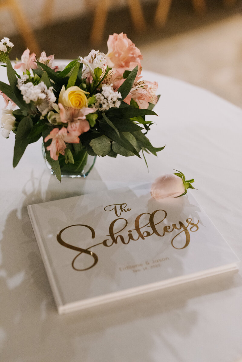 wedding guestbook next to flowers