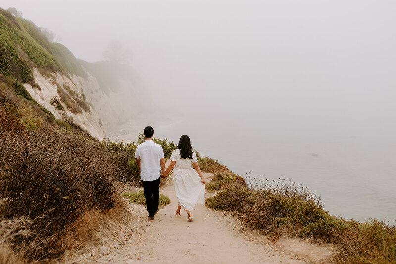 man and woman walking on path