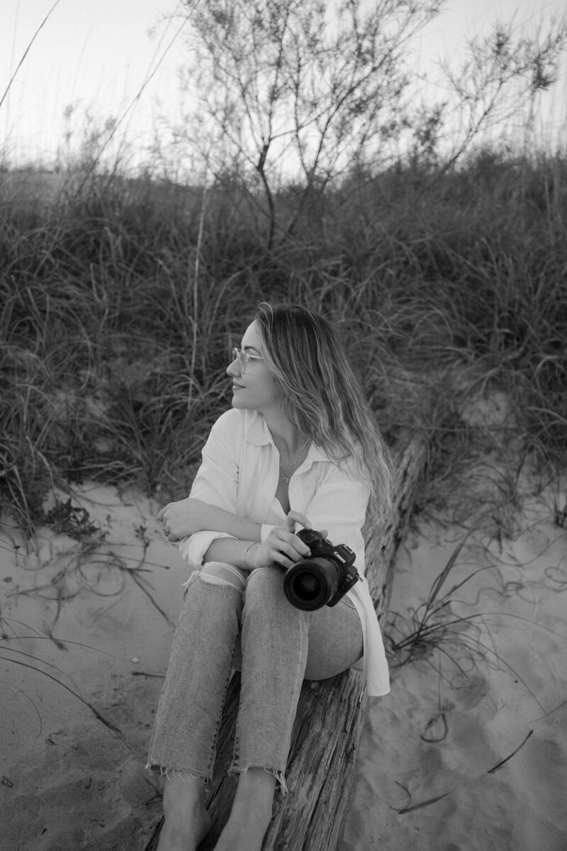Wedding photographer, Nayan Tadiello, on beach with camera