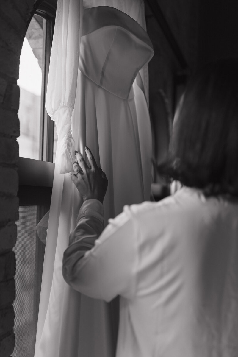 A romantic black and white wedding morning portrait, highlighting the bride’s anticipation and grace as she prepares for her destination wedding.
