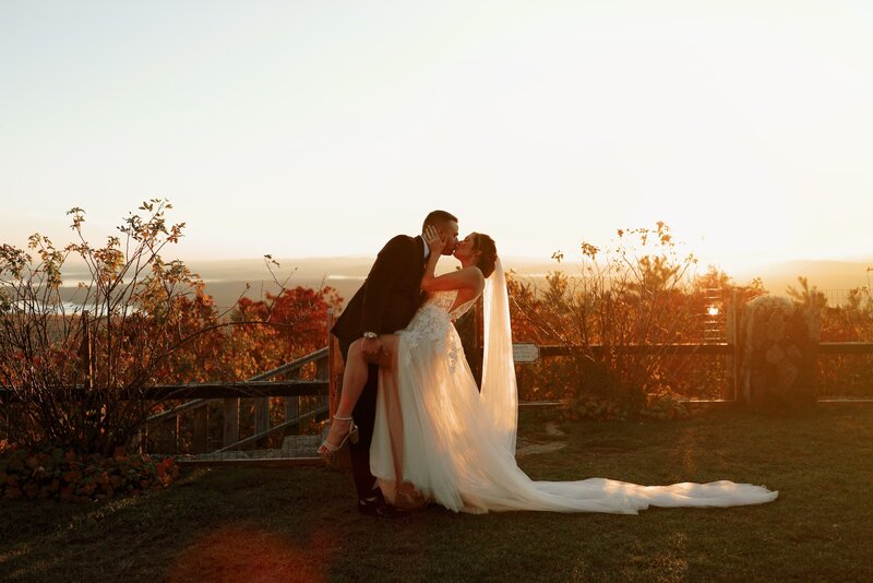 Bride and groom pose for a wedding portrait in a natural landscape