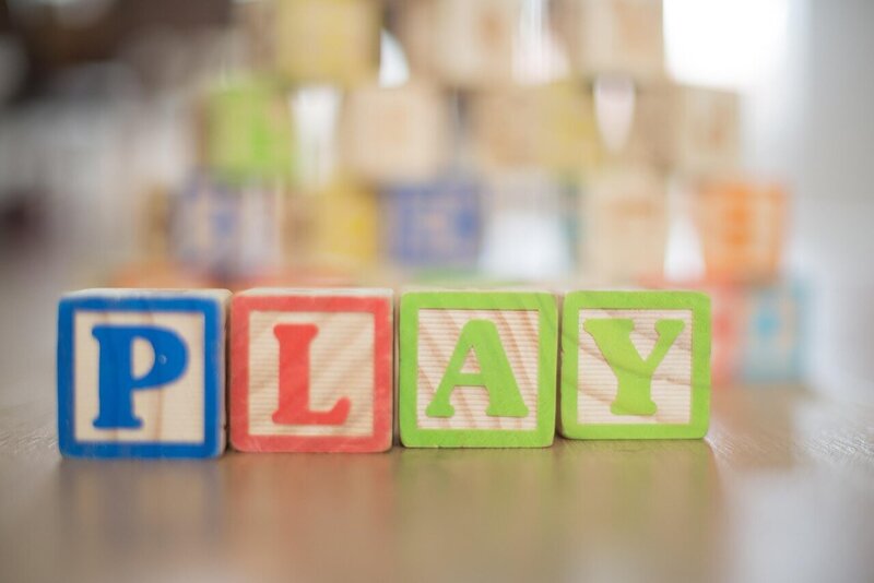 colorful wooden blocks spelling out PLAY