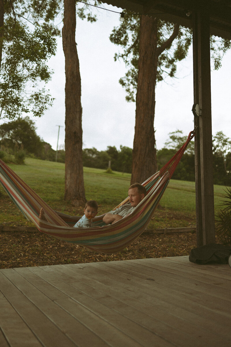 Father and son in hammock at farm stay photoshoot in Byron Bay