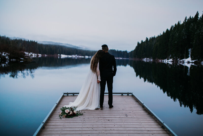 photo of married couple on a dock overlooking the water Oregon Coast Elopement and Wedding Photographer