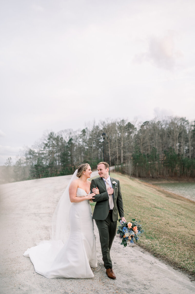 Bride and groom walk on gravel road at foxhall resort