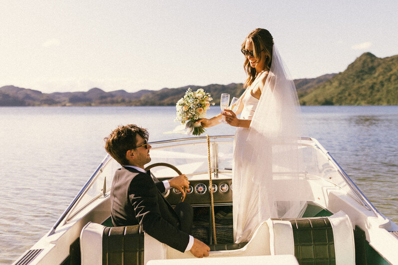 A couple celebrating their wedding on a boat at a Rotorua Lake in the Bay of Plenty