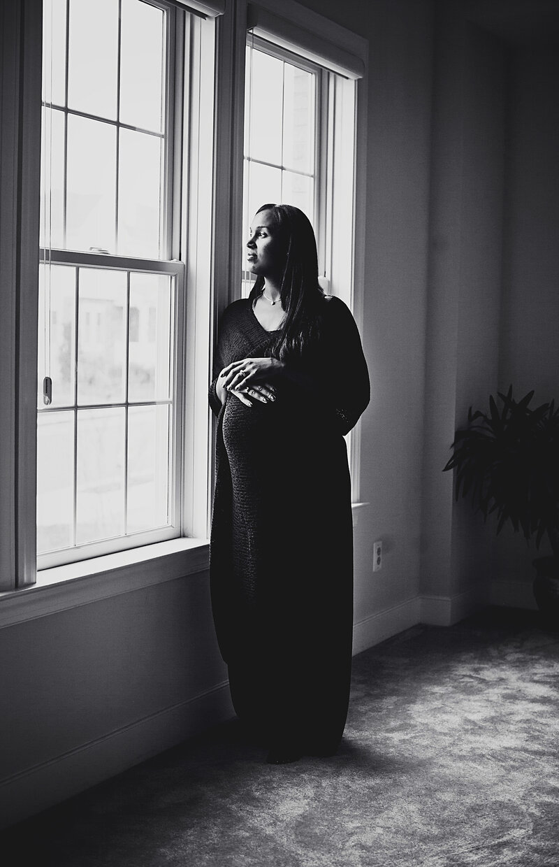 Black and white maternity session by window