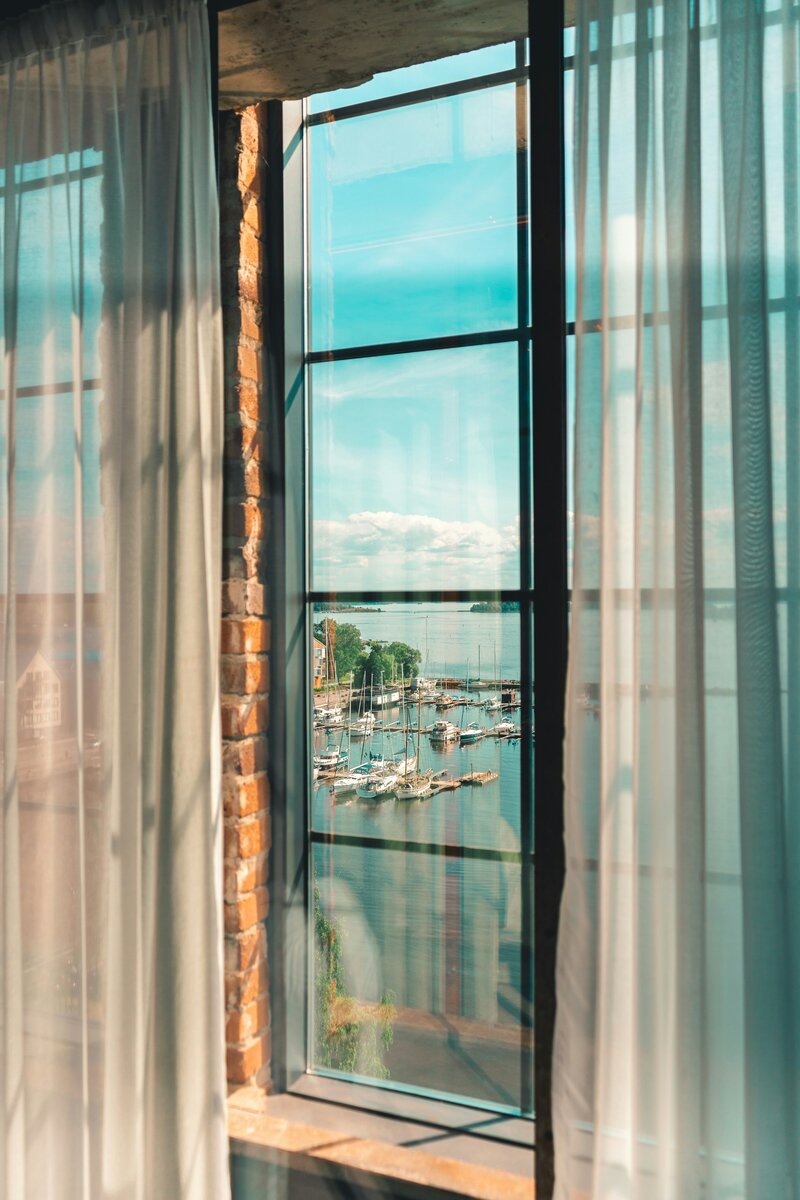 sailboat window through a window with curtains - tales of adventure