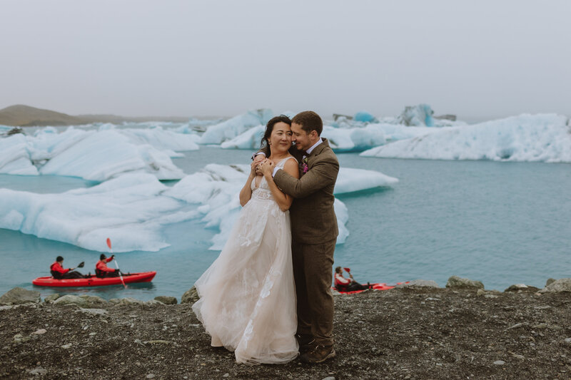 Bride and groom in front of iceberg