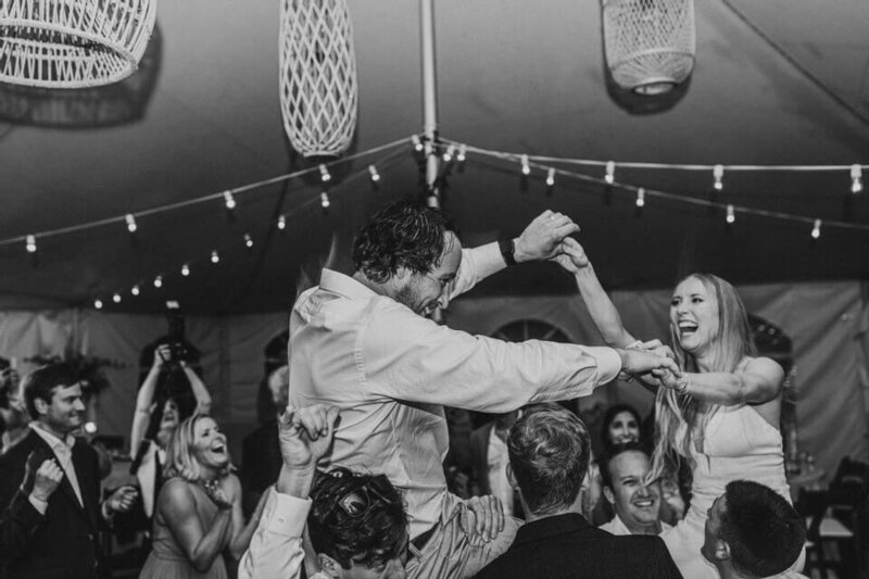 bride and groom crowd surfing at wedding reception party in greenwood delaware by sabrina leigh photography