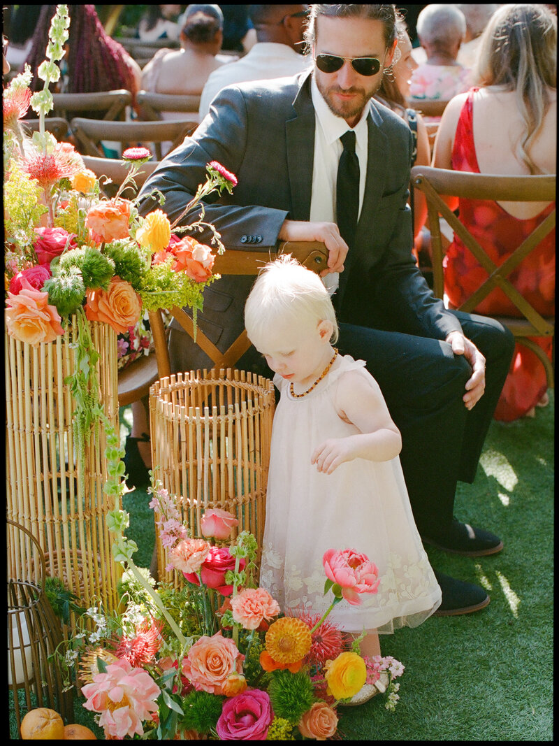 little girl looking at flowers