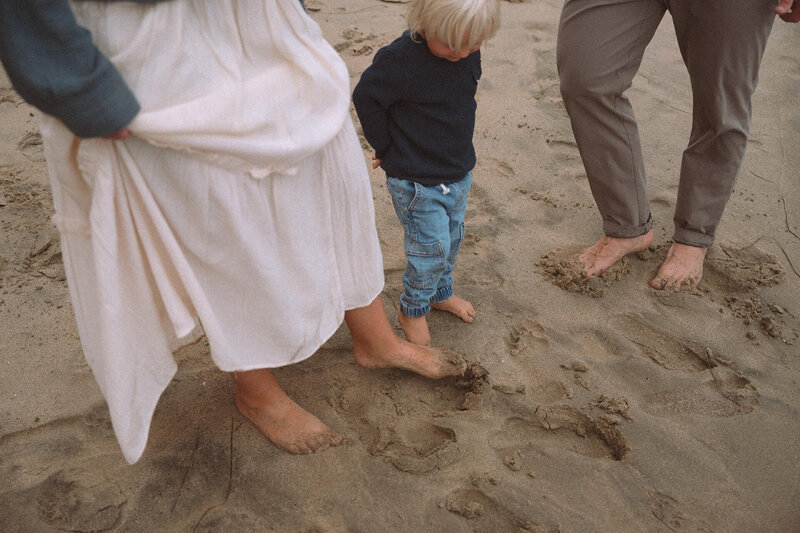 family with feet in sand near irvine california